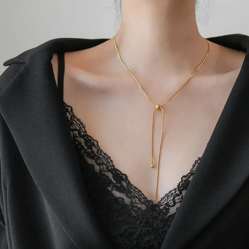 Gold Tone Knot Long Tassel Plunge Necklace